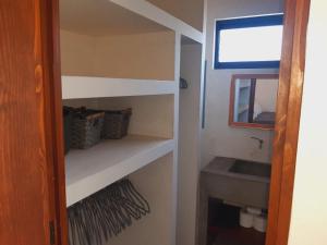 a small bathroom with a sink and a mirror at Zen Studio Full Kitchen & Outdoor Chill Space in La Ventana