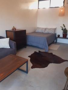 a living room with a bed and a couch at Zen Studio Full Kitchen & Outdoor Chill Space in La Ventana