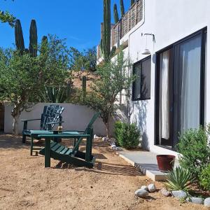 a patio with a bench and a table and a building at Zen Studio Full Kitchen & Outdoor Chill Space in La Ventana