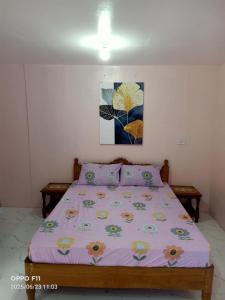 a bedroom with a bed with a purple comforter at Jch Apartment 17 Padua St Dubinan West in Santiago City +2 photos