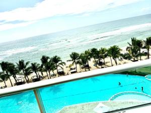 a view of the beach from the balcony of a resort at My sun in Juan Dolio