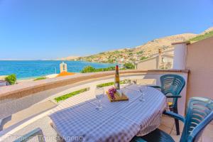 a table on a balcony with a view of the ocean at Zutenica Seaside Residence in Metajna +25 photos
