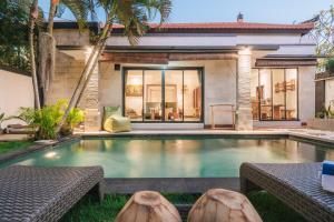 a swimming pool in the backyard of a house at Villa Chintana Sanur - Tropical lush landscapes, and serene atmospheres in Sanur
