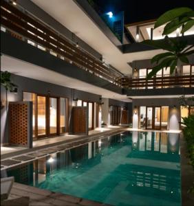 a swimming pool in the middle of a building at Atania Apartment in Jimbaran