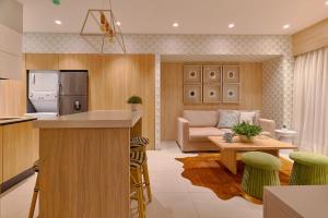 a kitchen and living room with a couch and a table at ®{Peaceful~Retreat} @DowntownSD HotTubGymFamily in Santo Domingo