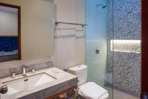 a bathroom with a sink and a shower and a toilet at Atania Apartment in Jimbaran +16 photos