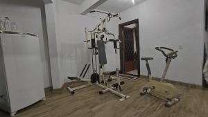a gym with several exercise bikes in a room at Pousada Ruby in Irati
