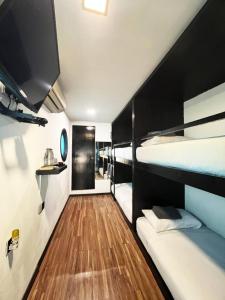a room with two bunk beds and a wooden floor at The Kabin in Jeram +42 photos