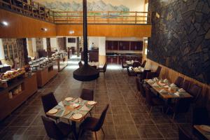 a restaurant with tables and chairs in a room at Azure Lagoon Resort in Ushu