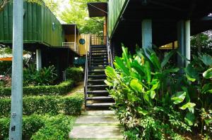 a stairway leading up to a building with green plants at The Kabin in Jeram