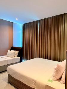 Postel nebo postele na pokoji v ubytování Stirling Suites Hotel & Serviced Apartment