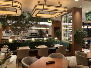 a restaurant with tables and chairs and a bar at lyf Shibuya Tokyo in Tokyo
