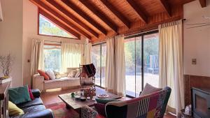a living room with a couch and a table at Oceana Suites Laguna de Aculeo in Paine