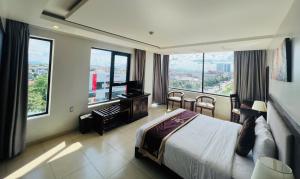 a hotel room with a bed and large windows at Golden Quang Tri Hotel in Ðông Hà +42 photos