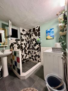 a bathroom with a shower with a tiled wall at Almadovarhouse in Makhinjauri +119 photos