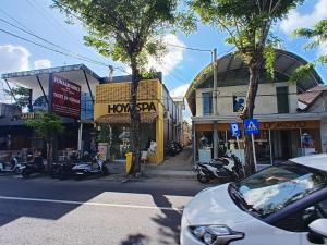 a city street with a car parked in front of buildings at Cozy villa 2bdr in Seminyak , pool,800m beach in Seminyak