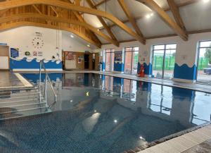 a swimming pool in a building with a swimming pool at The Rainbow's nest in Morecambe
