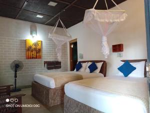 Postel nebo postele na pokoji v ubytování Summer villa Ambagolla