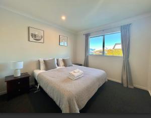 a bedroom with a large bed and a window at Supernova B -2 Bedrooms in Lake Tekapo