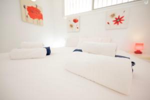 a white room with two beds and a window at Seagulls melody C-209 in Adeje