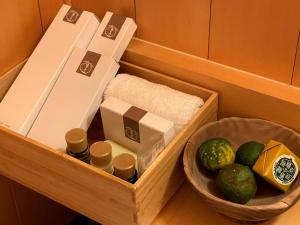 a wooden box with food and a basket of produce at Yuzuya Ryokan - Adult Only in Kyoto +47 photos