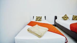 Voodi või voodid majutusasutuse SMW Lodge Sigiriya toas
