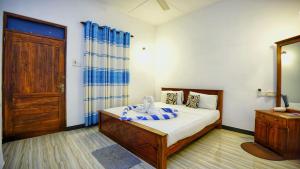 Voodi või voodid majutusasutuse SMW Lodge Sigiriya toas