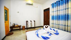 Voodi või voodid majutusasutuse SMW Lodge Sigiriya toas