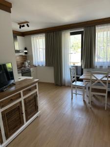 a living room with a kitchen and a dining room table at House Egger - Top 202 in Bad Kleinkirchheim +31 photos