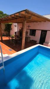 a swimming pool in front of a house at Casa Orquídea con Alberca en Centro Histórico in Parras de la Fuente