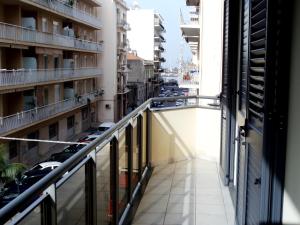 a balcony in a building with a view of a street at Nerissa Holiday Apartment Milazzo in Milazzo