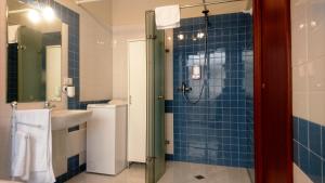 a bathroom with a shower and a sink at Nerissa Holiday Apartment Milazzo in Milazzo +28 photos