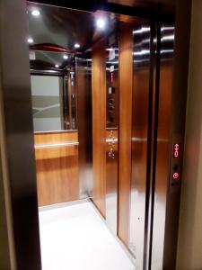 an empty elevator in a room with a mirror at Nerissa Holiday Apartment Milazzo in Milazzo