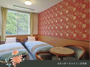 Rúm í herbergi á Hinotani Onsen Misugi Resort