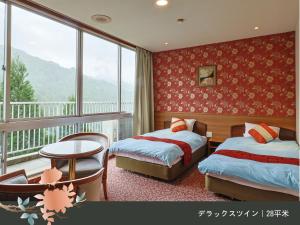 Rúm í herbergi á Hinotani Onsen Misugi Resort