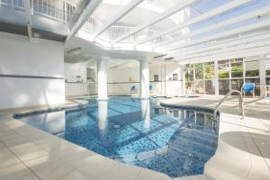 a large swimming pool in a building at Burleigh Surf Apartments in Gold Coast