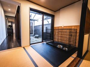 a room with a large window and a dog cage at 松江日和 by HIYORISTAY in Matsue +46 photos