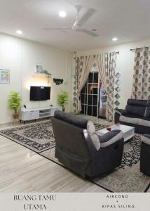 a living room with a couch and a tv at Kuantan SnakeRiver Homestay in Kampung Sungai Ular +40 photos