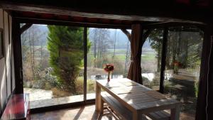 a room with a table and a large glass window at Pré Le Duc in Broglie