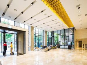 a large lobby with large windows and people walking in it at Hotel Denim Seoul in Seoul