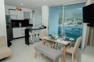 a kitchen and dining room with a table and chairs at Hermoso apartamento. Cerca del mar. in Santa Marta