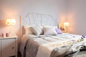 a bedroom with a large bed with two lamps at Il Borghetto in San Lorenzo in Campo
