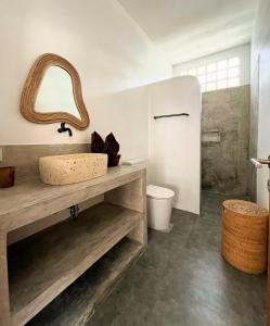 a bathroom with a sink and a mirror at VILLA LULU 1- 2 bedrooms villa - private pool in Kuta Lombok