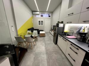 a kitchen with a table and chairs in a room at Mandouki Urban Stay in Corfu +6 photos