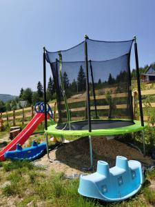 a playground with a trampoline and other play equipment at Casa din Dâmb Mătișești in Mătişeşti