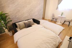 Postel nebo postele na pokoji v ubytování フォルモント寺田町 203