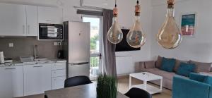 a kitchen and a living room with a couch at Glikeria Loft Apartment in Volos