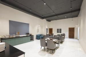 a dining room with tables and chairs in a room at White Ridge Premium Hotel - Hitec City in Hyderabad