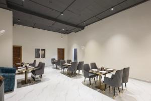 a restaurant with tables and chairs in a room at White Ridge Premium Hotel - Hitec City in Hyderabad