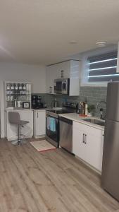 a kitchen with white cabinets and a counter top at Newly Built Private Basement Suite in Prescott in Spruce Grove